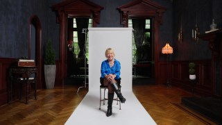 A woman sitting on a chair in a room.